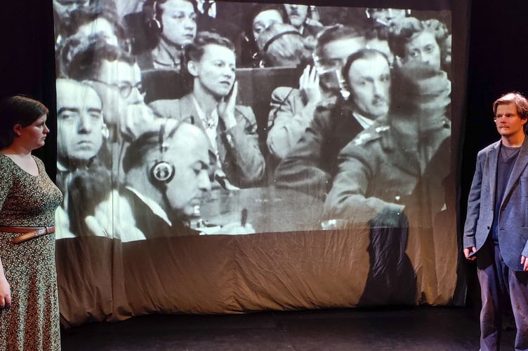 Lily Casson and Robert Blackmore with a projection of their great grandparents, Sylvia and David Maxwell Fyfe