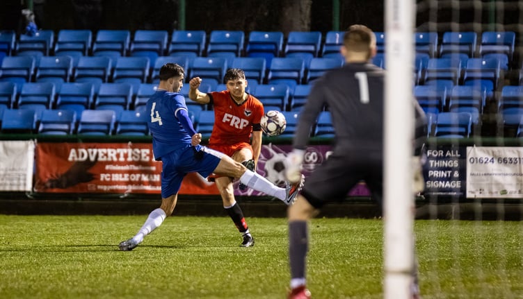 Jacob Crook swings in a cross for FC Isle of Man against Ramsbottom United at the Bowl last weekend (Photo: Gary Weightman)