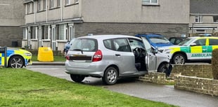 Emergency services at scene as car crashes into garden wall