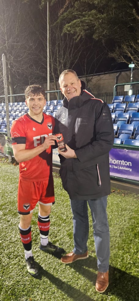 Jacob Crook receives the Man of the Match award from Andrew Brearley, director of sponsor Grant Thornton 