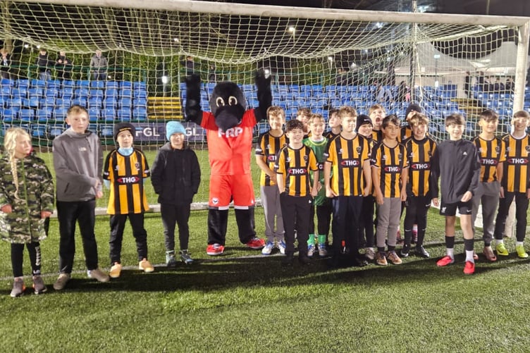 FC Isle of Man mascot Raymond the Raven with Rushen juniors at Saturday evening's game