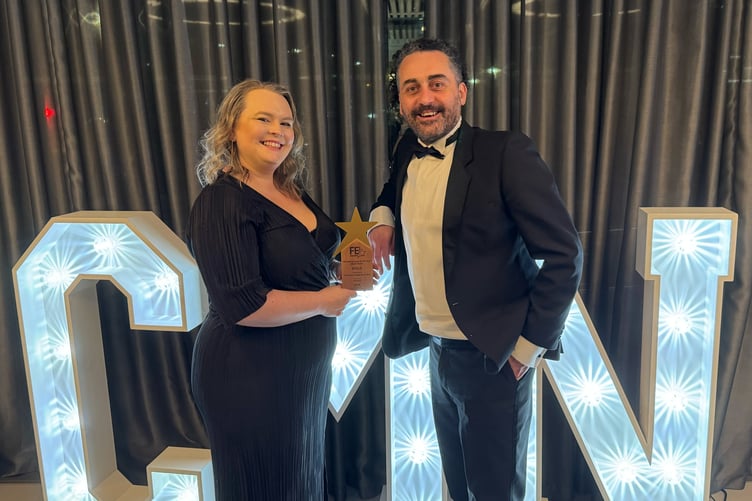 Roxy Langstaff and Alessandro Mazzotta collecting the award