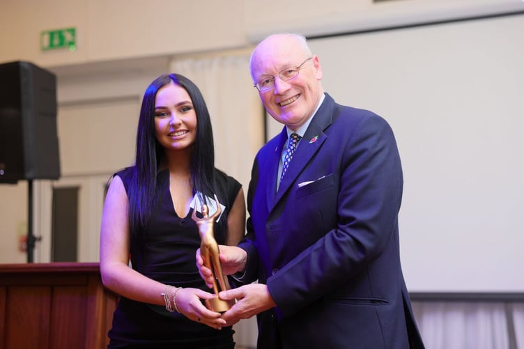 Patience Gore accepting her trophy from Lieutenant General Sir John Lorimer winner the public main prize