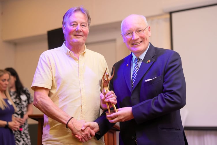 Father of Grace Miller accepting the trophy from Lieutenant General Sir John Lorimer winner of the Judges Main Prize