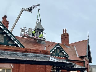 Watch as railway station belfry is craned off roof