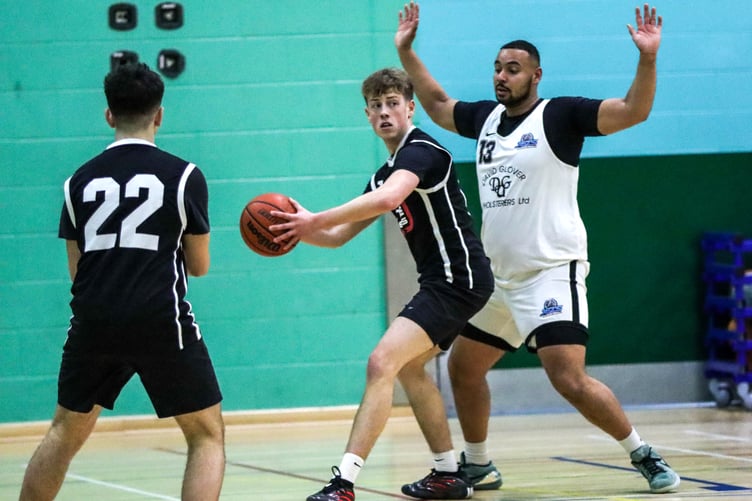 DGU Jets' Peter Boussougou defends the low post as Cannons Elite's Jack Wilkinson looks for the outlet pass during Thursday's match-up (Photo: Ben Campbell)