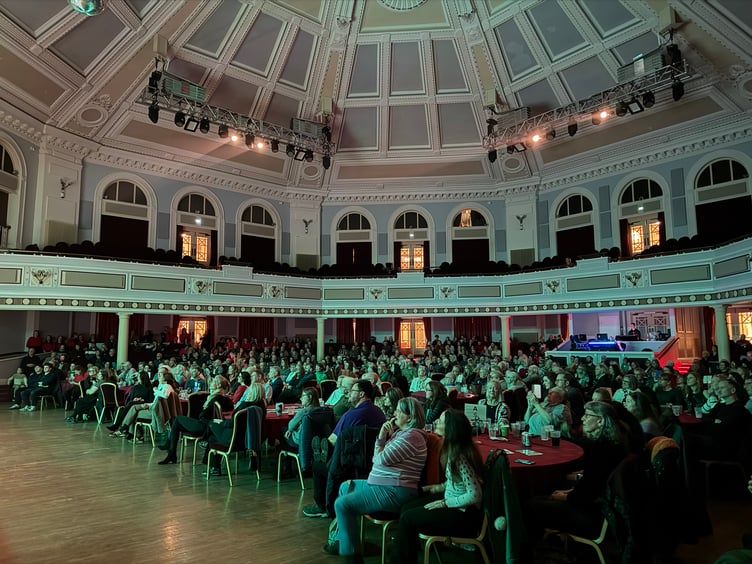 The crowd inside the Royal Hall watch on