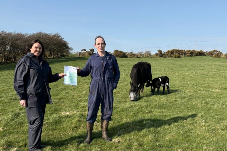 Lauren Kirk from the DEFA's animal health team hand-delivered the first passport issued through the new system to Richard Creer at Ballabunt Farm