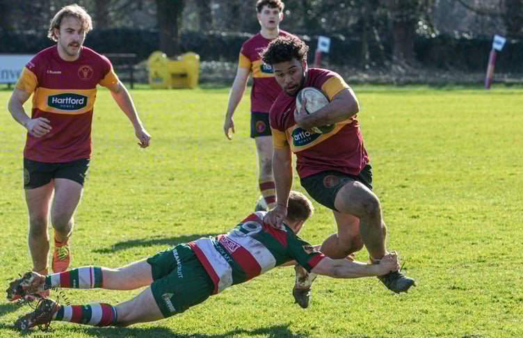 Josh Campbell on the charge for Douglas as he attempts to hurdle a challenge from a Waterloo opponent during Saturday's battle at Port-e-Chee (Photo: Richard Ebbutt)
