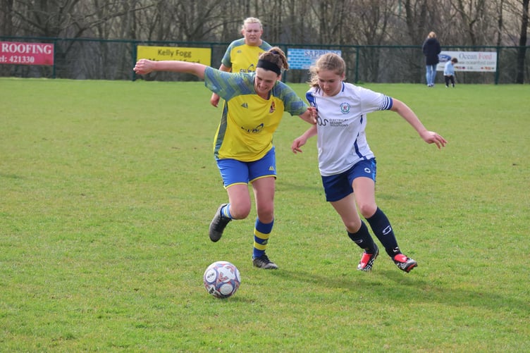 Onchan's Amy Beggs-Cairney and Douglas Royal's Mika Chen (right) jostle for the ball during Sunday's match at Ballafletcher (Photo: Paul Hatton)