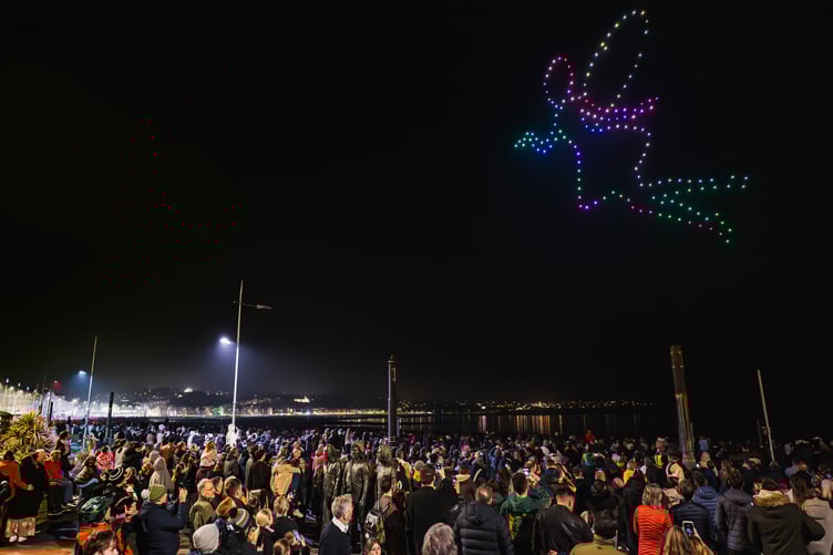 A fairy floats over the crowds during the drone show in Douglas