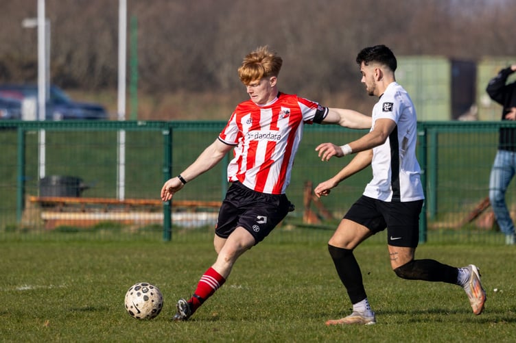 Peel's Tomas Brown under pressure from Corinthians' Joao Marques (right) during Saturday's ECAP FA Cup semi-final at Ballafletcher (Photo: Gary Weightman)
