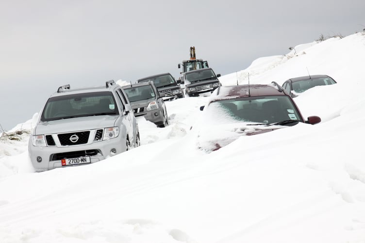 Snow buried cars on the Braaid to Cooil Road in St Marks