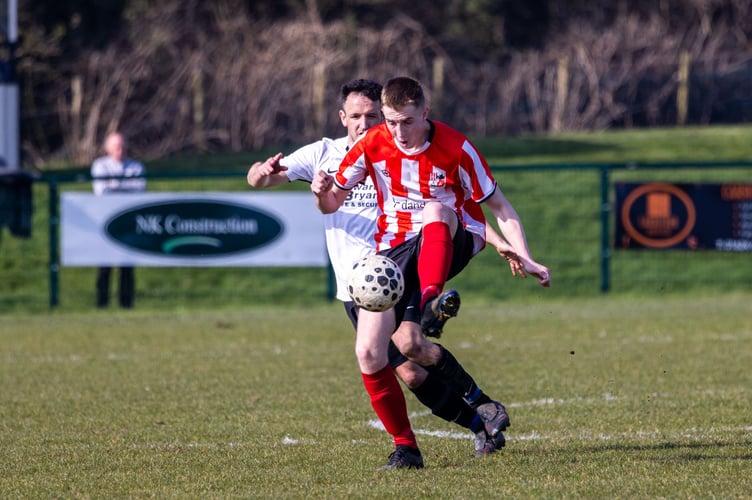 Peel's Jason Charmer shields the ball from Corinthians' Darren Cain during Saturday's ECAP FA Cup semi-final at Ballafletcher (Photo: Gary Weightman)