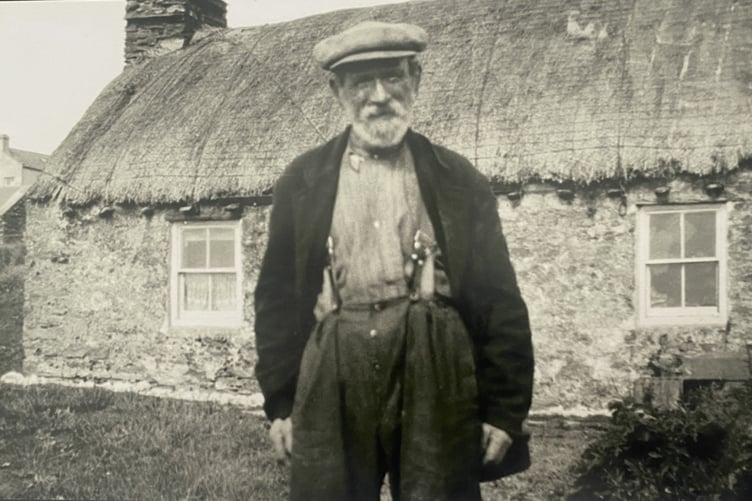 Harry Kelly outside his cottage