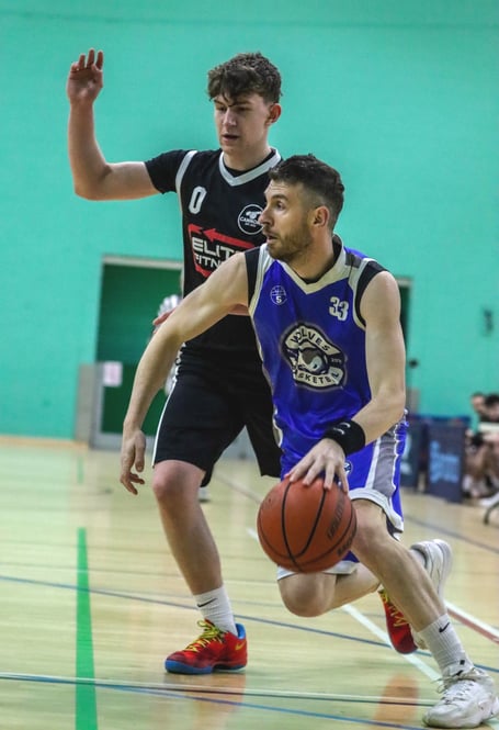 Wolves' Viktor Capkanovski dribbles past the defence of Cannons Elite's Oliver Hamilton during Thursday's clash at the NSC. Wolves snatched a 71-61 victory over Cannons in the fourth quarter, having trailed for the entire game (Photo: Martin Dunne)