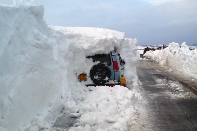 A car trapped in several fee of snow in Kirk Michael