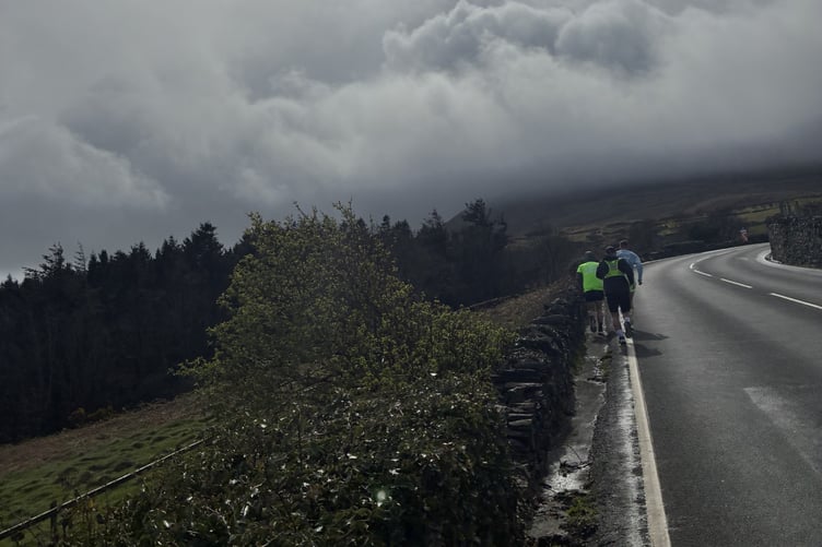 Josh Thomas, Danny Roberts and Shaun McEntee running along the TT course