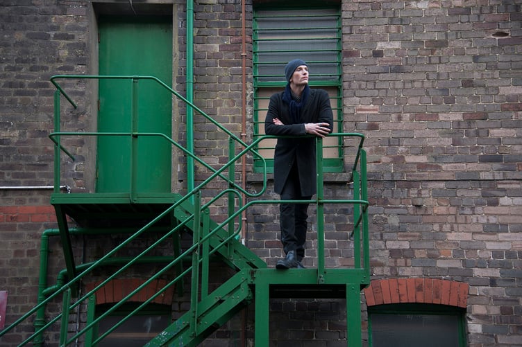 Will Holden posing outside the back of the Gaiety Theatre