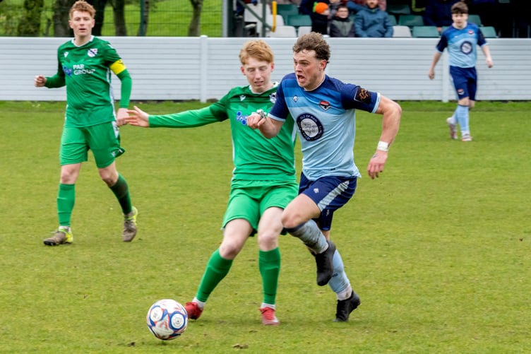 FC Isle of Man's Dean Pinnington looks for a way past a Charnock Richard opponent on Saturday (Photo: Hannah McHugh)