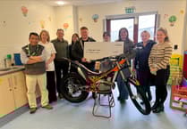 Tom Knight hands over cheque for £6,000 to children's ward