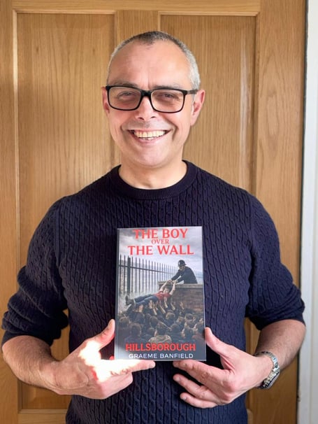 Graeme Banfield with his book 'The boy over the wall'