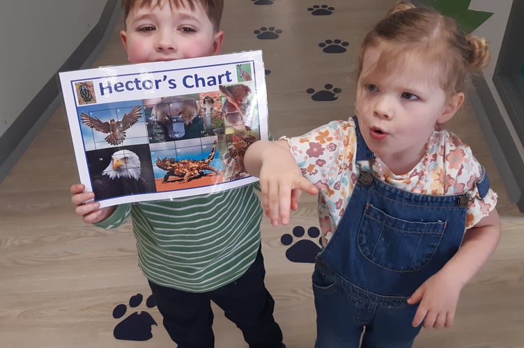 Hector and his little sister Dottie, with his treatment chart at the Christie
