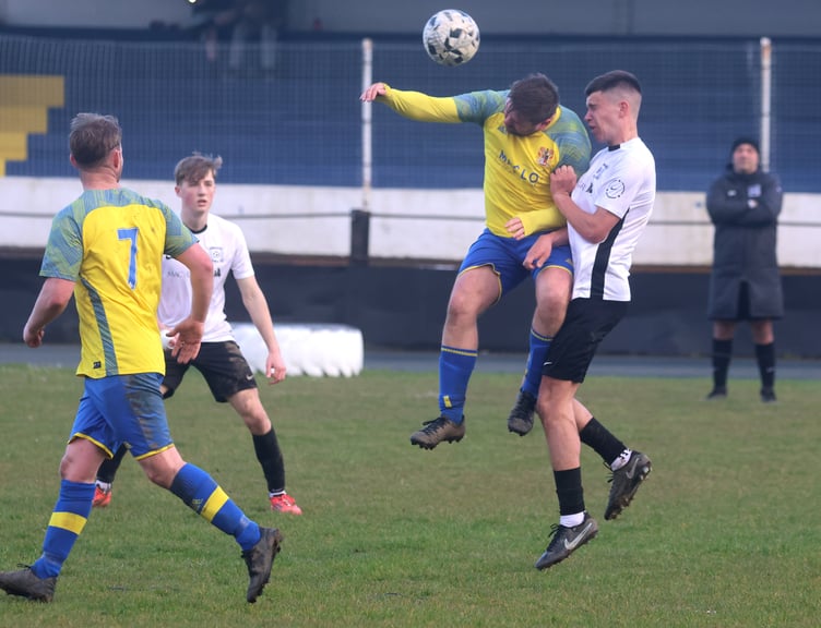 Onchan's John Parker and Corinthians' Oscar Christian challenge for a header during Wednesday evening's Combination One clash at the Nivison Stadium (Photo: Paul Hatton)