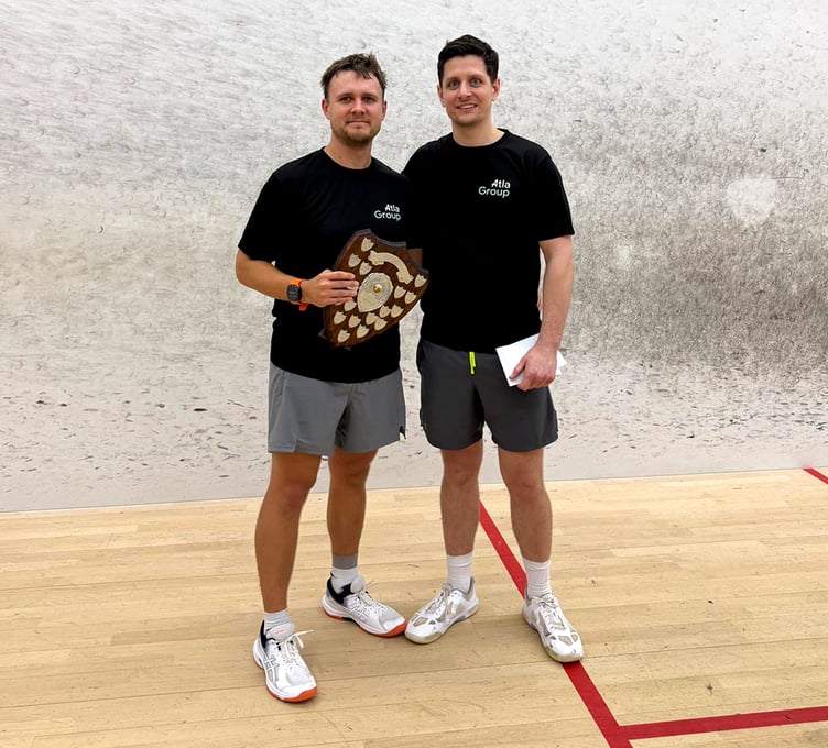 Island squash champion Thomas Whiteway (left) with the championship shield alongside Phil Butler of competition sponsor Atla Group