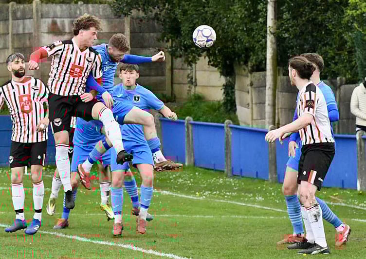 FC Isle of Man's Dean Pinnington rises highest to challenge for a header against Padiham during Saturday's Premier Division clash (Photo: Mike Shaw)