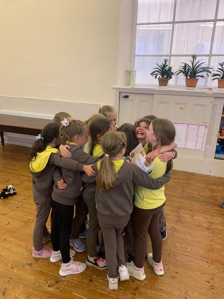 Previous Brownies having a group hug before moving on up to Girl Guides