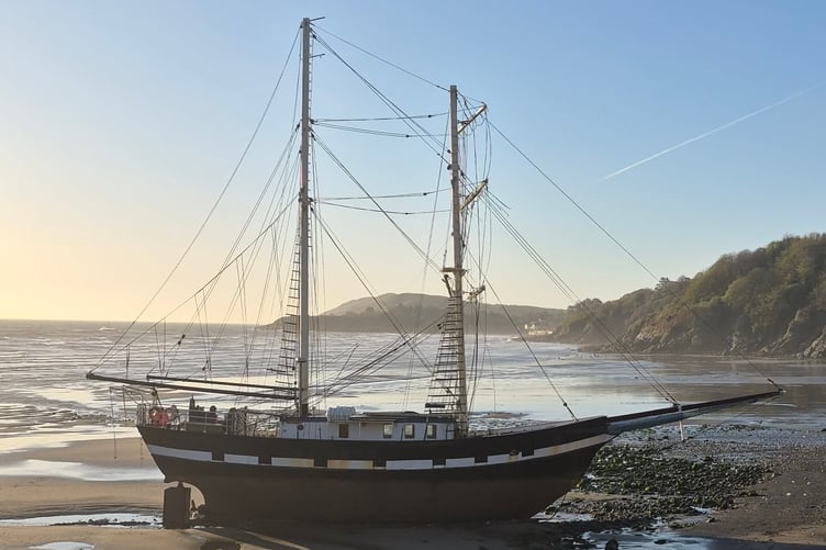 The tall ship La Malouine stranded high up on Ramsey south beach