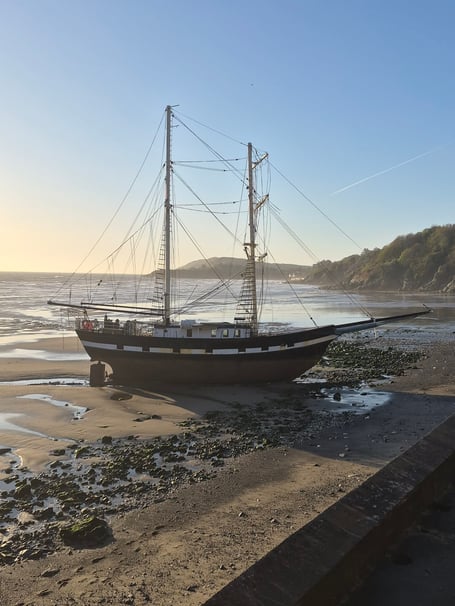 The tall ship La Malouine stranded high up on Ramsey south beach