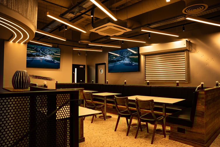 A seating area inside the new venue accompanied by TV screens