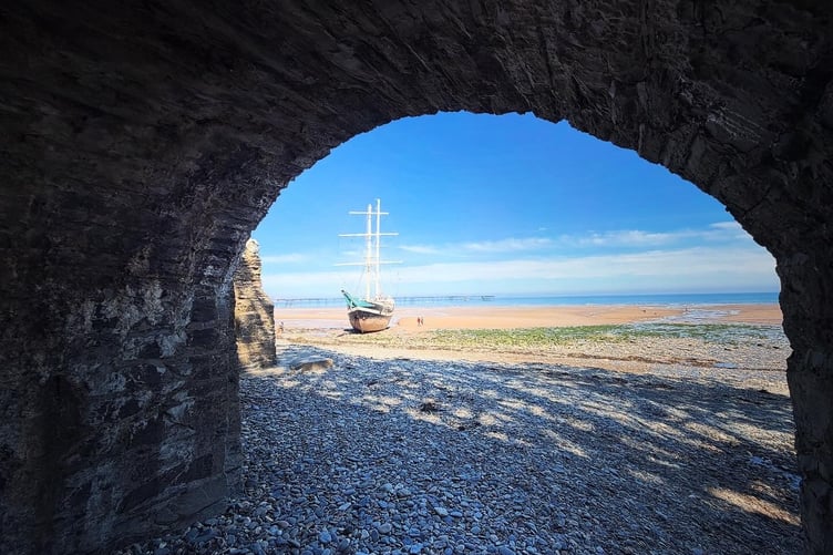 The La Malouine seen through the arches at Ballure beach