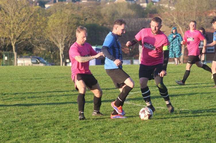 Douglas Athletic's Graham Druggan (left) and Stuart Monks (right) challenge RYCOB's Martyn Murphy (Photo: Paul Hatton)