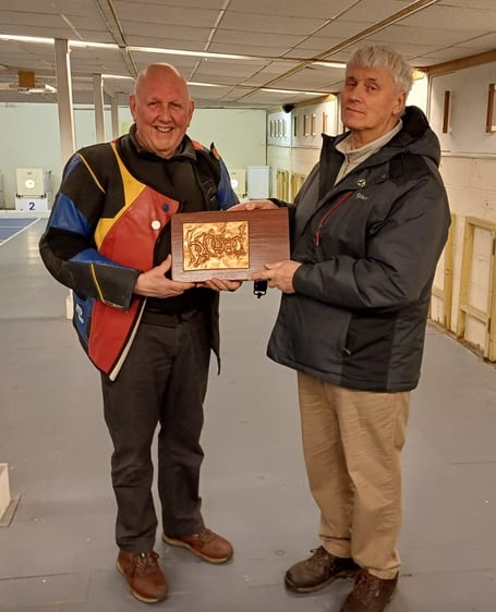 Laxey’s Harry Creevy (left) receives the ‘100’ Trophy from competition secretary Richard Arthur at the Sinclair Range