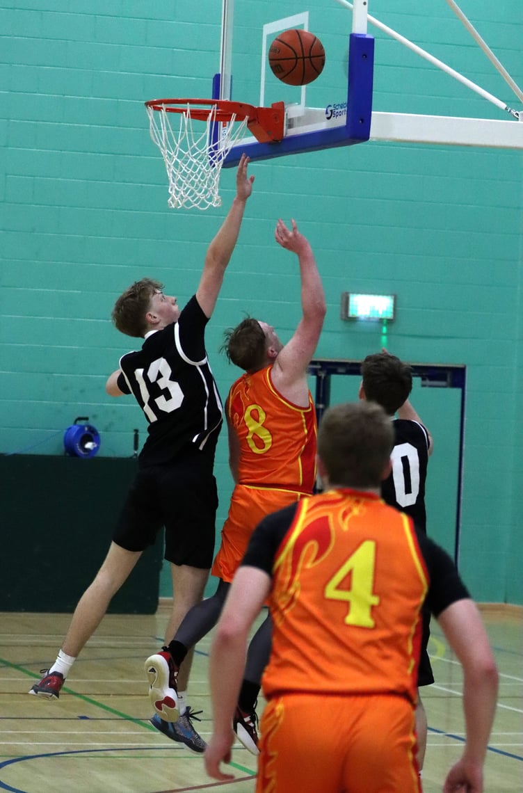 Michael Pardoe (No.8) goes for the lay-up as Cannons' Jack Wilkinson attempts to block from behind during Thursday evening's play-off clash at the NSC