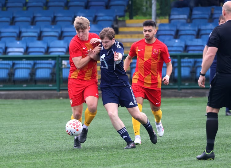 The Isle of Man's Kyle Watson (left) tussles for possession with a Halewood Apollo opponent during Saturday's match (Photo: Paul Hatton)