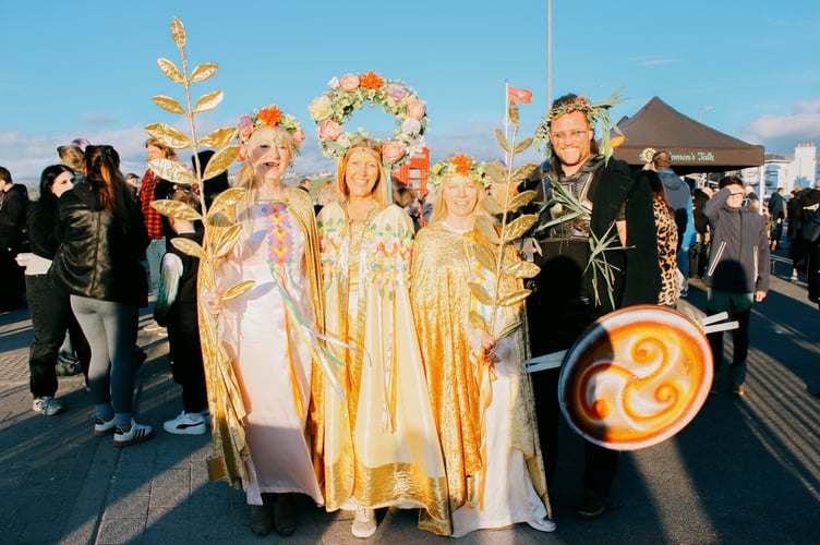 The Summer Queen pictured with the circle flower head dress is Jo Pickering. Juan Callister is pictured to the far right, alongside friends.