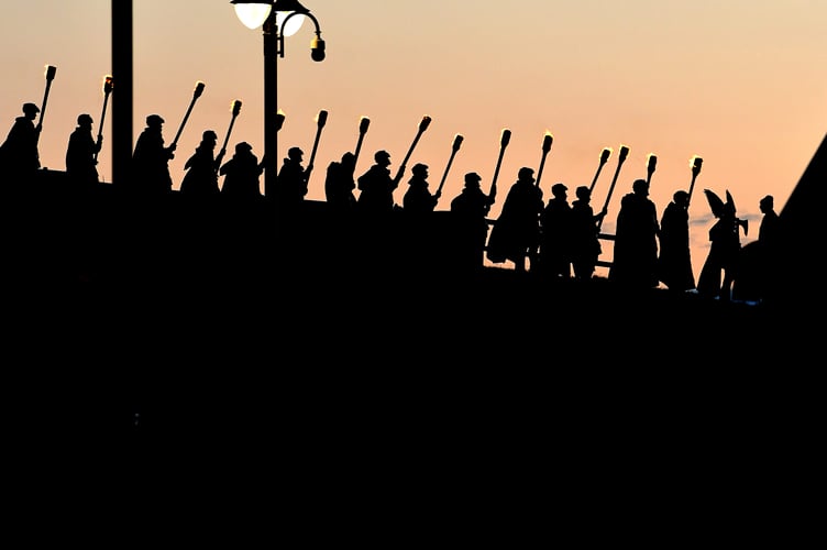 Viking warriors silhouetted against the twilight