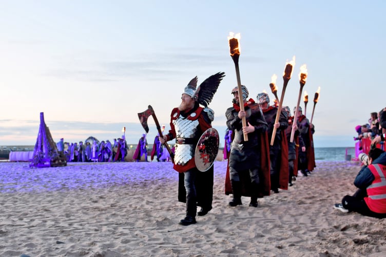 The Guizer Jarl leads the Shetland Vikings onto the beach