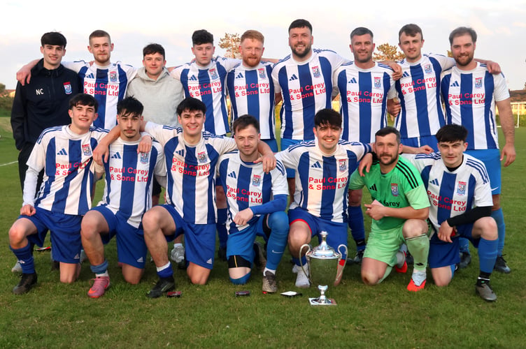 Ramsey players celebrate with the Canada Life Combination One trophy after Wednesday's match at Croit Lowey (Photo: Paul Hatton)
