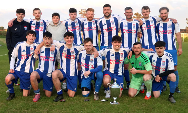 Ramsey players celebrate with the Canada Life Combination One trophy after Wednesday's match at Croit Lowey (Photo: Paul Hatton)