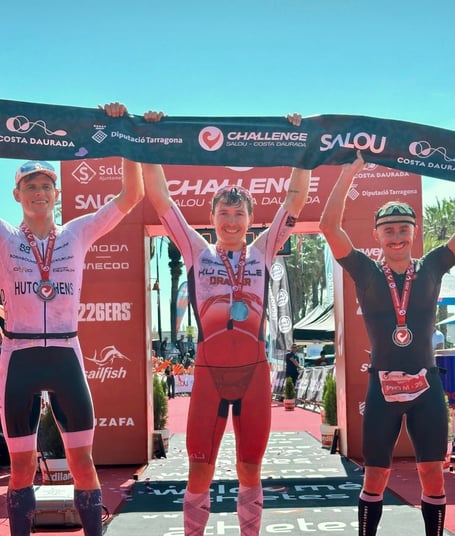 Will Draper (centre) after winning his fifth professional triathlon win at the weekend