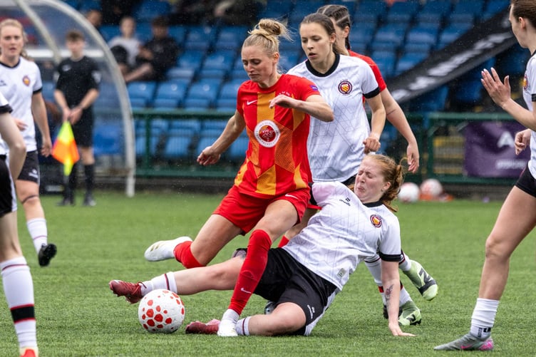 Sarah Wignall is challenged by an FC United of Manchester opponent during Saturday's friendly at the Bowl (Photo: Gary Weightman)