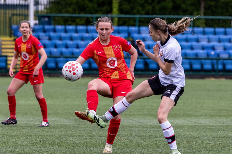 Lisa Costain and an FC United player compete for possession during the weekend's match at the Bowl (Photo: Gary Weightman)