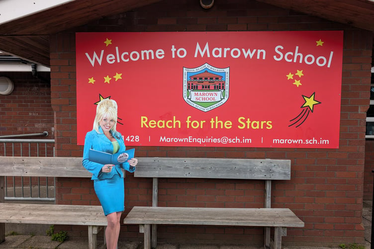 A cardboard cutout of Dolly Parton outside Marown School