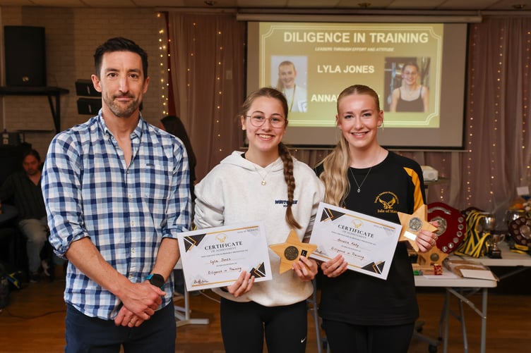 Lyla Jones and Annalia Raby are awarded for diligence in training, pictured with head coach James Wright (left)