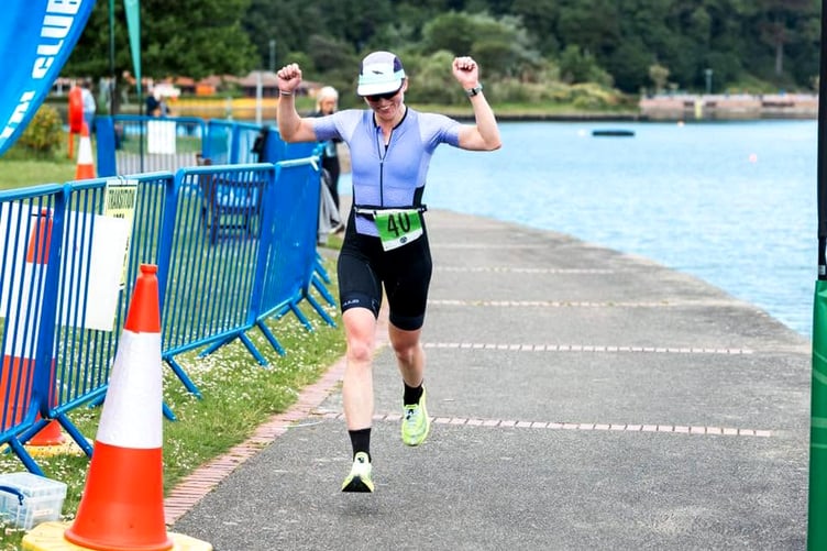 Amber Carridge celebrates as she crosses the finish line to second in the women's class and 10th place overall (Photo: DK Photography)